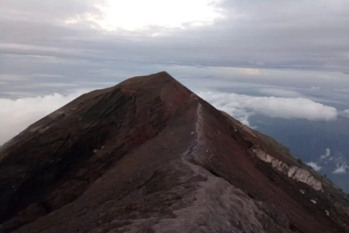 A view of the volcanic crater rim of Mount Agung above the clouds.