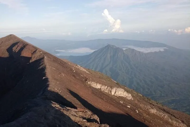 The crater rim of Mount Agung with another mountain in the distance.